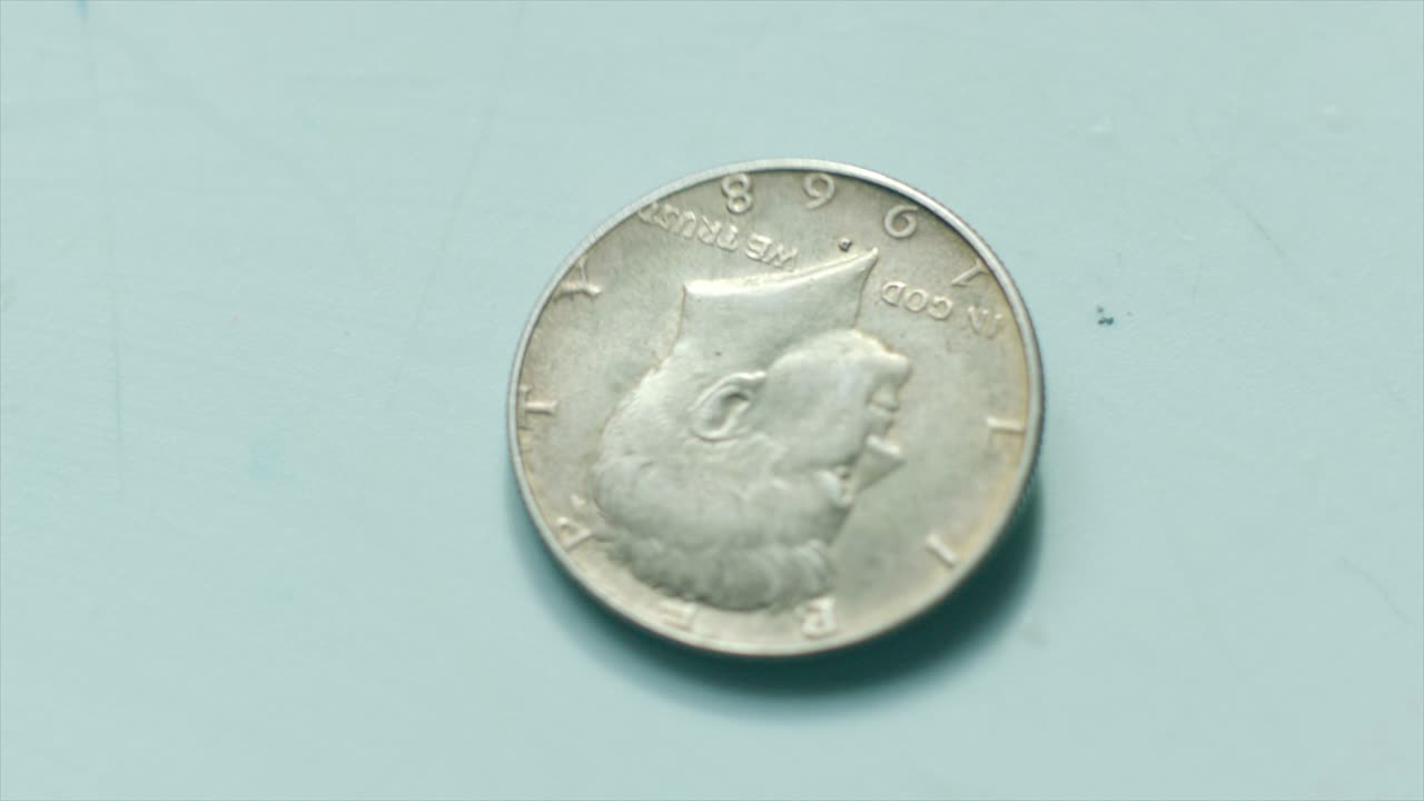 Coin of 50 cents value stopping to spin