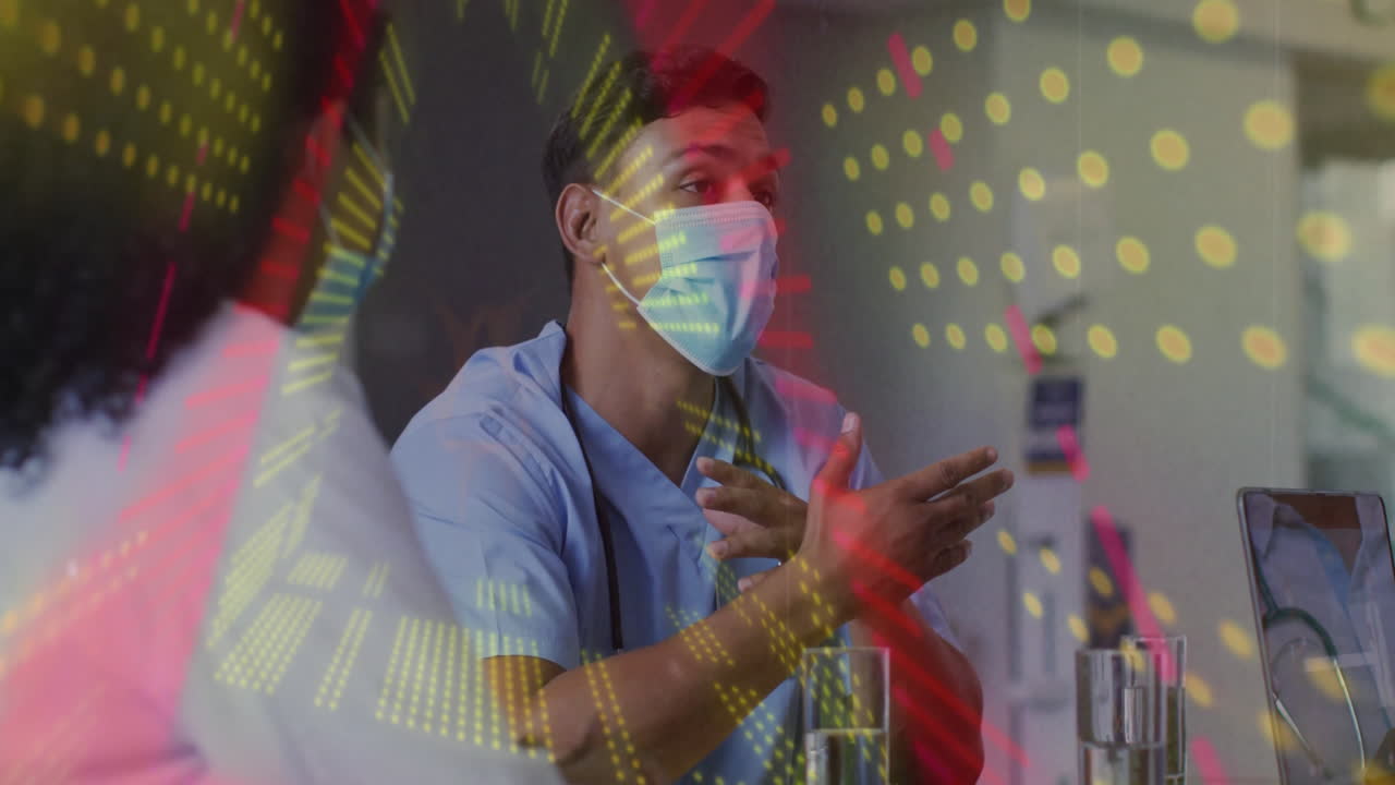 Healthcare professional gesturing while discussing patient data showing laptop and digital graphics