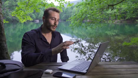 businessman speaking at live conference with laptop.