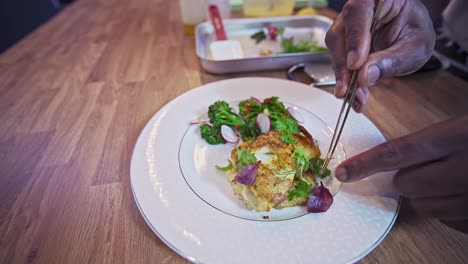 Chef-Africano-Bañando-Bacalao-Braseado-En-Un-Plato-Blanco