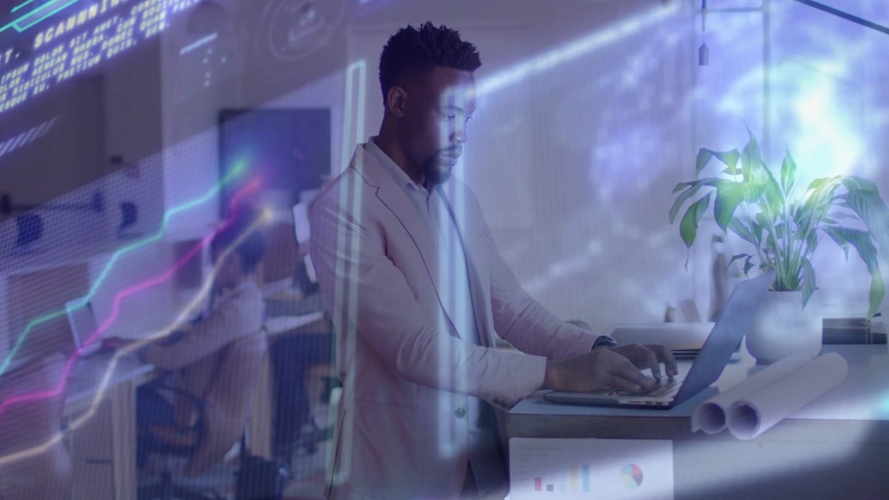 Man standing at desk typing on laptop, live tech feed sweeping overlays and graphs for analysis