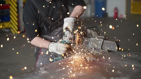 A-man-working-with-angle-grinder,-sparkles,-super-slow-motion