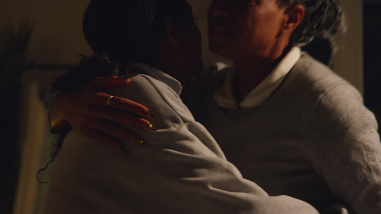 madre e hija se abrazan en la noche