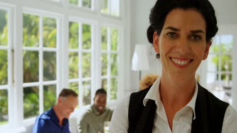 Smiling-waitress-standing-in-restaurant