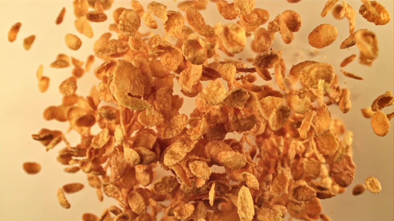Golden Cornflakes Floating and Falling in Slow Motion