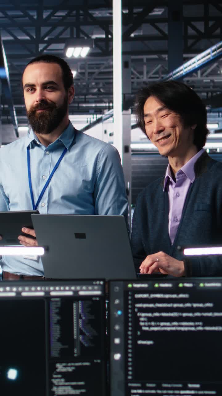 Vertical video Happy data center colleagues collaborating on software development