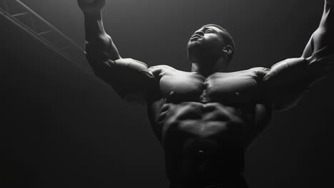 bodybuilder posing under stage lights showing muscles