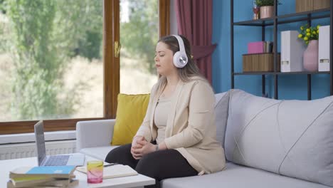 Unhappy-young-woman-listening-to-music-with-headphones.