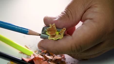 Footage-of-hands-slowly-sharpening-a-pencil-and-some-coloured-pencils-with-a-Wedge-Pencil-Sharpener