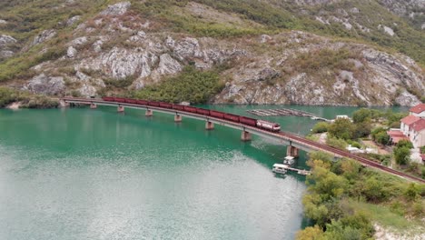Aerial: freight train on a bridge over the Neretva River in Bosnia and Hercegovina