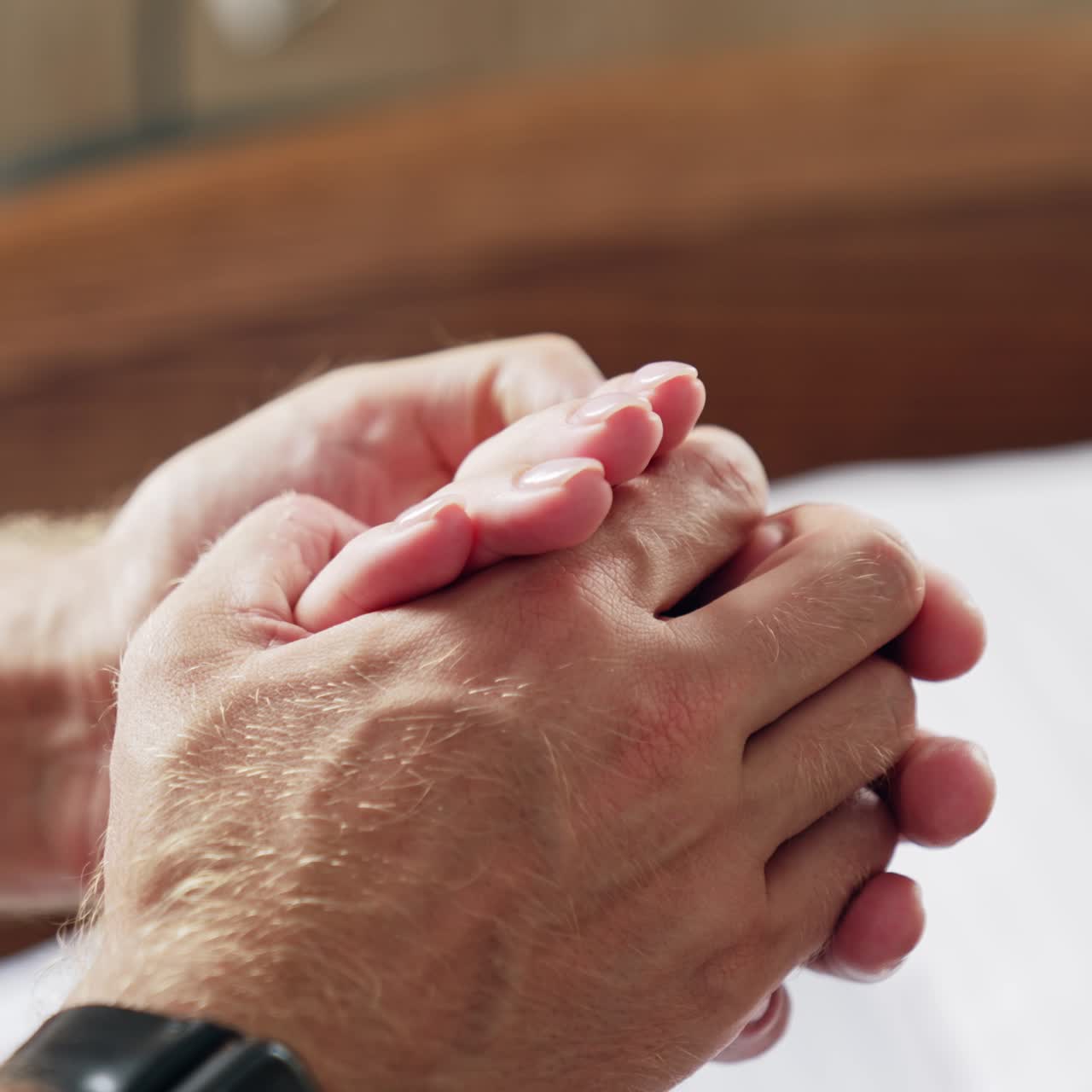 Male hands holding female hand. Man supporting and soothing his wife. Close up