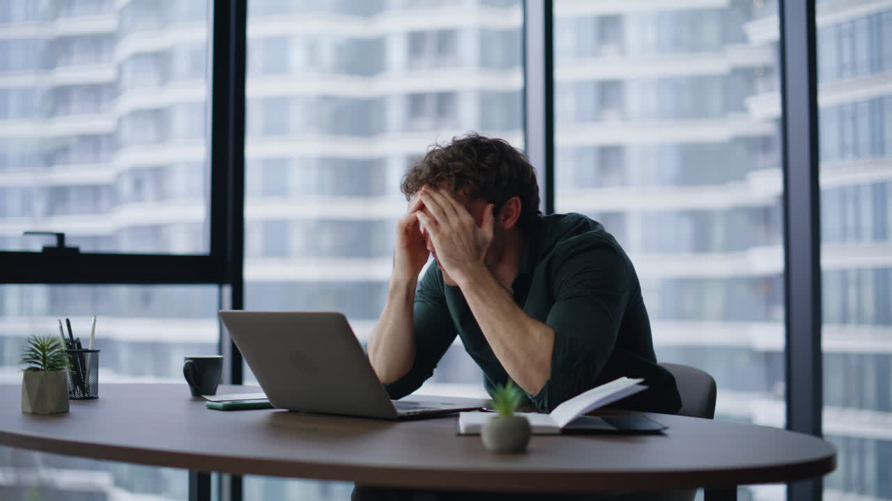 Entrepreneur reacting business failure emotionally looking laptop in workplace
