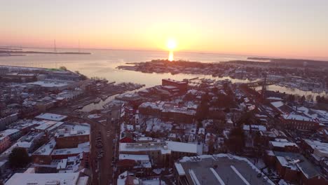 Soaring-towards-a-golden-sun-rise-over-downtown-historic-Annapolis,-Maryland-and-Eastport