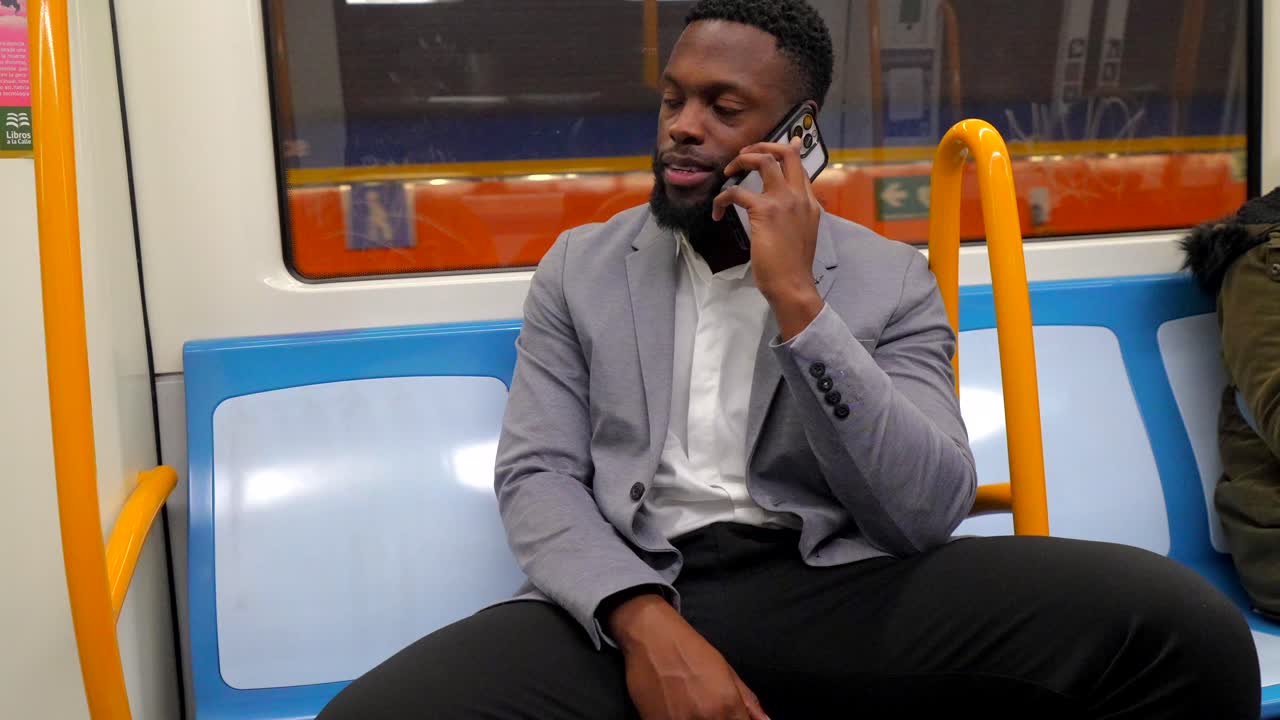 Man on Subway Talking on Phone