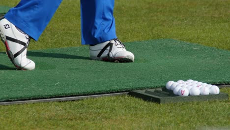 golfer practicing putting on a golf range