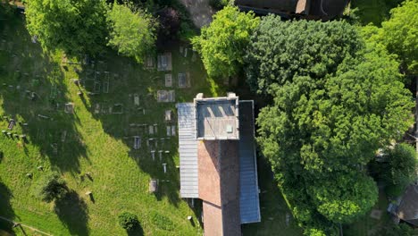 a top-down pull-out shot of st andrew's church in wickhambreaux, pulling out to reveal the surrounding graveyard