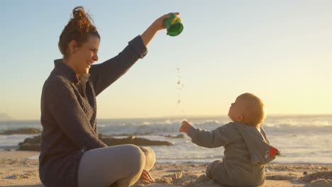 Mother-playing-with-her-baby-boy-in-the-beach-4k