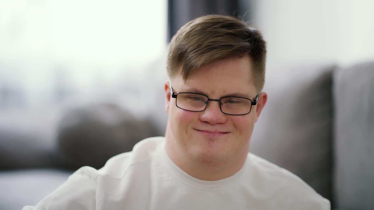 Kind young man with down syndrome against blrred background