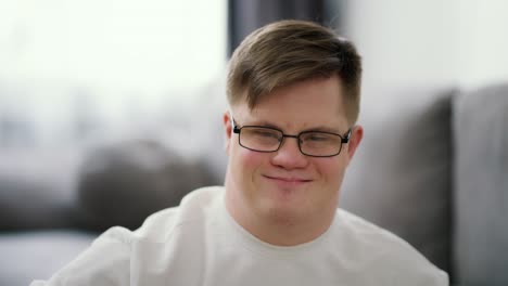 kind young man with down syndrome against blrred background