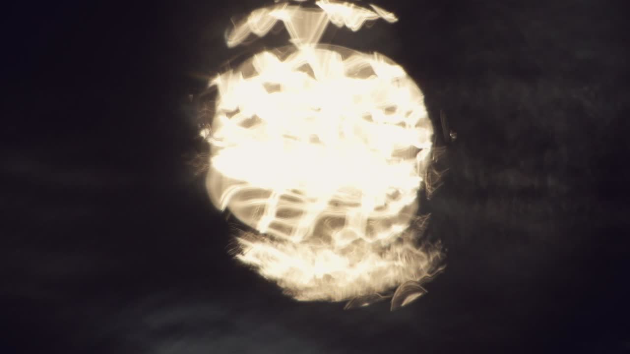 Reflection of light bloom bokeh in moving water, calm pleasant beauty