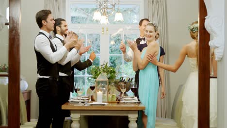 Bride-and-groom-walking-hand-in-hand-while-guests-applauding-4K-4k