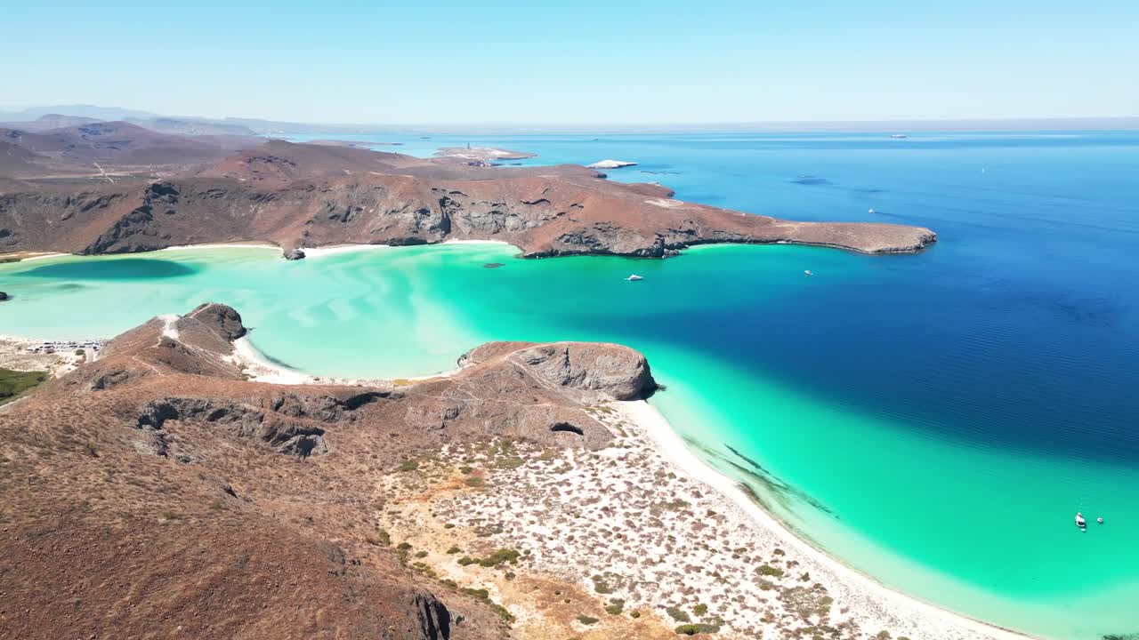 Breathtaking aerial view of Tecolotito Beach, La Paz, with turquoise waters and mountains