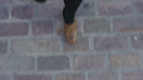 business woman walking on pavement wearing stylish leather shoes strolling casual in city commuting top view