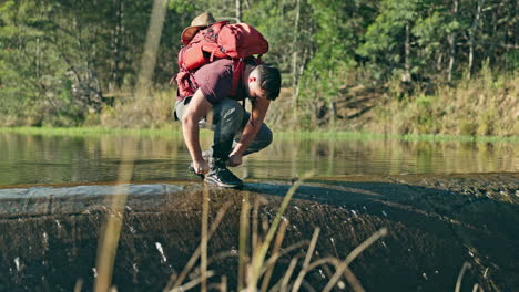 Man,-hiking-and-tie-shoelace-in-forest