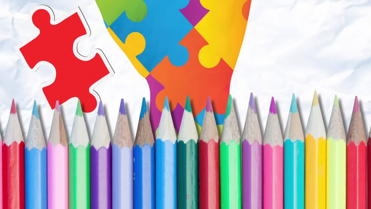 animación de rompecabezas que caen sobre la mano formada con rompecabezas y lápices de color
