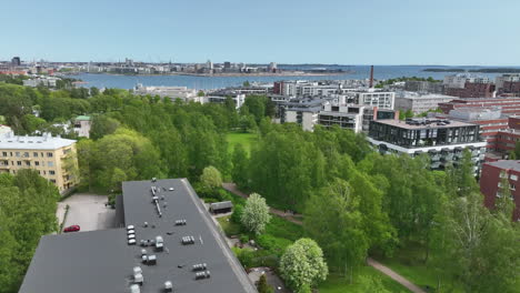 aerial view around spring colored trees in a park, in sunny lauttasaari, helsinki