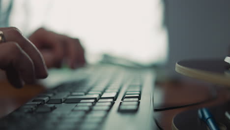 Employee-presses-Enter-on-computer-keyboard-working-at-table