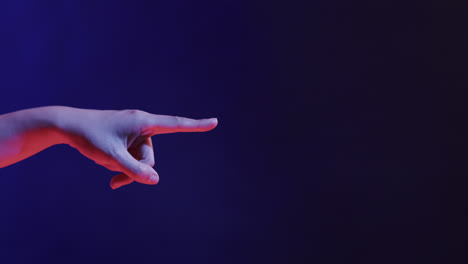 hand of asian woman, touching virtual screen on blue background, copy space, slow motion