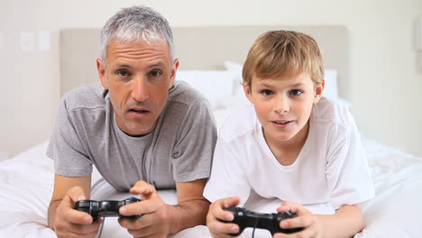 smiling father and son playing video games