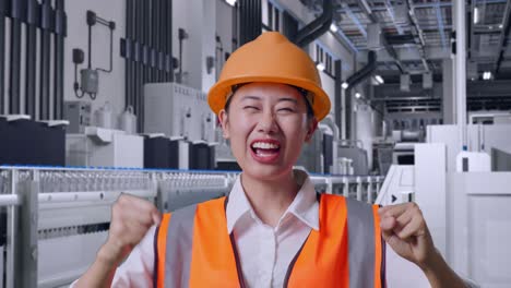 Close Up Of Asian Female Engineer With Safety Helmet Screaming Goal And Dancing Celebrating With Water Production in Bottling Factory