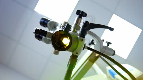 modern enabled microscope in a lab. scientific equipment for coronavirus testing in the laboratory. microbiology concept. view from below on bright light from microscope.