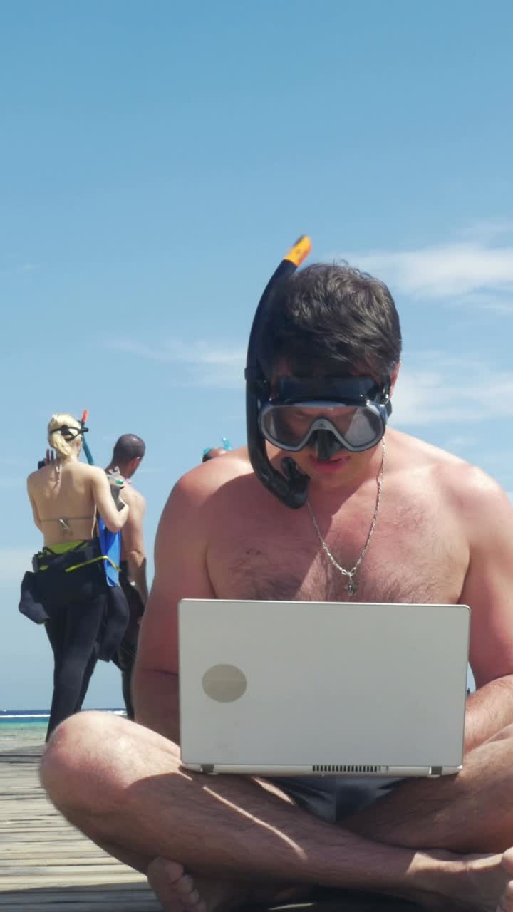 Man Working on Laptop While Snorkeling at the Beach