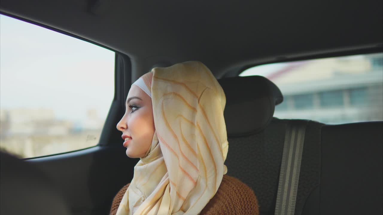 Woman in Hijab Riding in a Car