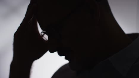 Close-Up-Silhouette-Of-Depressed-Mature-Man-Struggling-With-Mental-Health-In-Slow-Motion-2