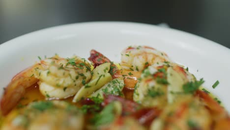 Close-up-of-Mediterranean-shrimp-soup-with-green-Parsley-plate,-health-seafood-keto-diet