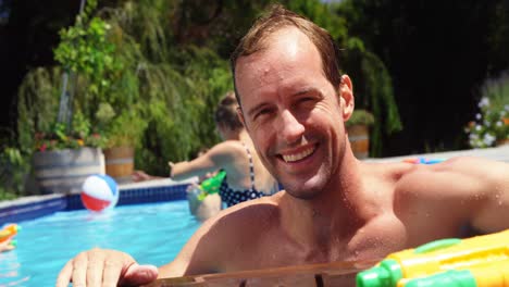 portrait of man smiling near swimming pool