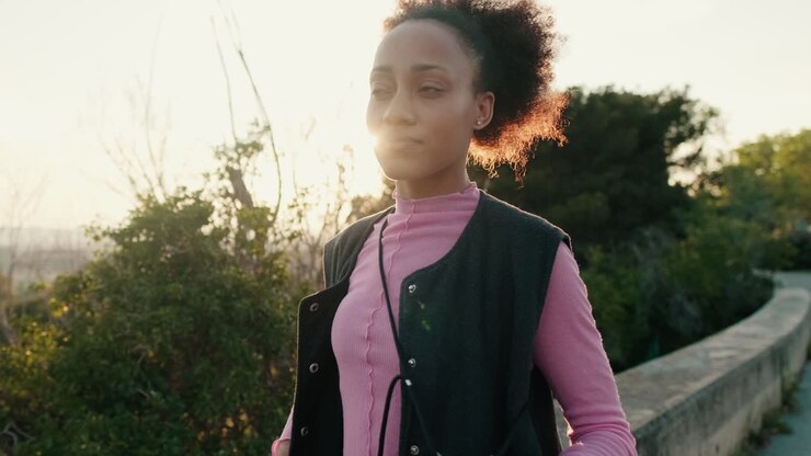 Woman Dances While Walking at Sunset