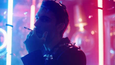 Thinking-man-blowing-smoke-at-party-in-slow-motion.-Hot-guy-smoking-in-nightclub