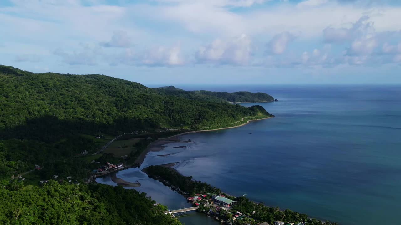 Aerial forward hyperlapse of lush tropical island coastline and turquoise ocean lagoon during daytime - Batalay, Catanduanes, Philippines