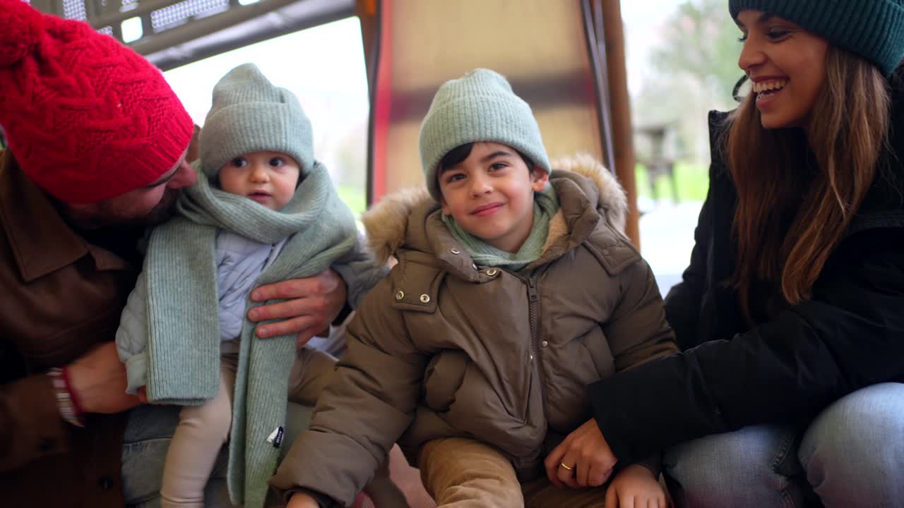 Family Having Fun on a Slide at the Playground
