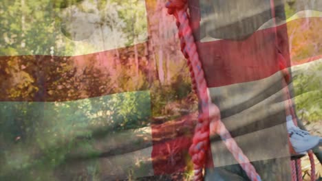 animation of flag of england over african american boy during obstacle race training