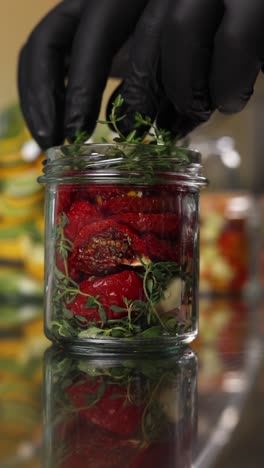 preparing sun-dried tomatoes in jars