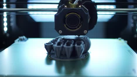 a 3d printer operates in a workshop, skillfully producing a detailed model. the process showcases the intricate design technology and creativity involved in three-dimensional printing.