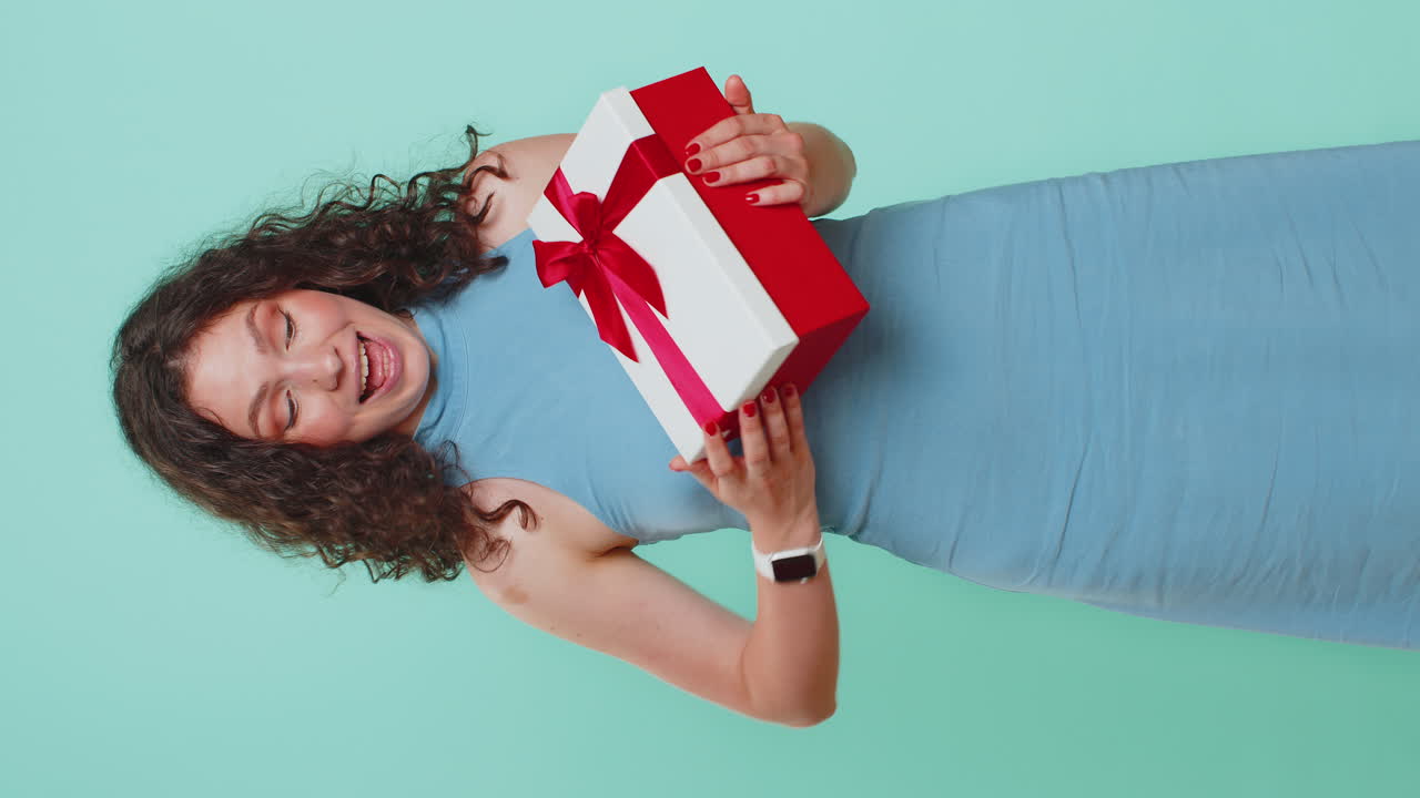 Woman presenting birthday gift box offer wrapped present career bonus celebrating party sale