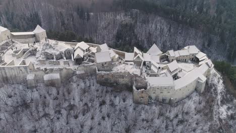 aerial slide of rasnov citadel in romania, during winter time