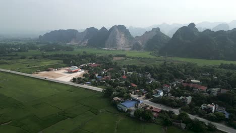 aerial view of a rural vietnamese village with mountains in the background